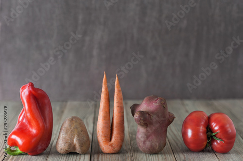 Vegetables on wooden  background. Imperfect Ugly food.