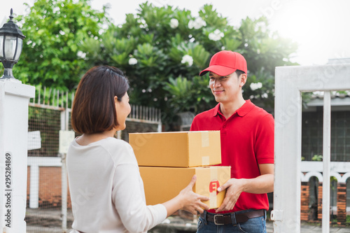 Photography Asian delivery man deliver box parcel package to customer at home, shipping deli