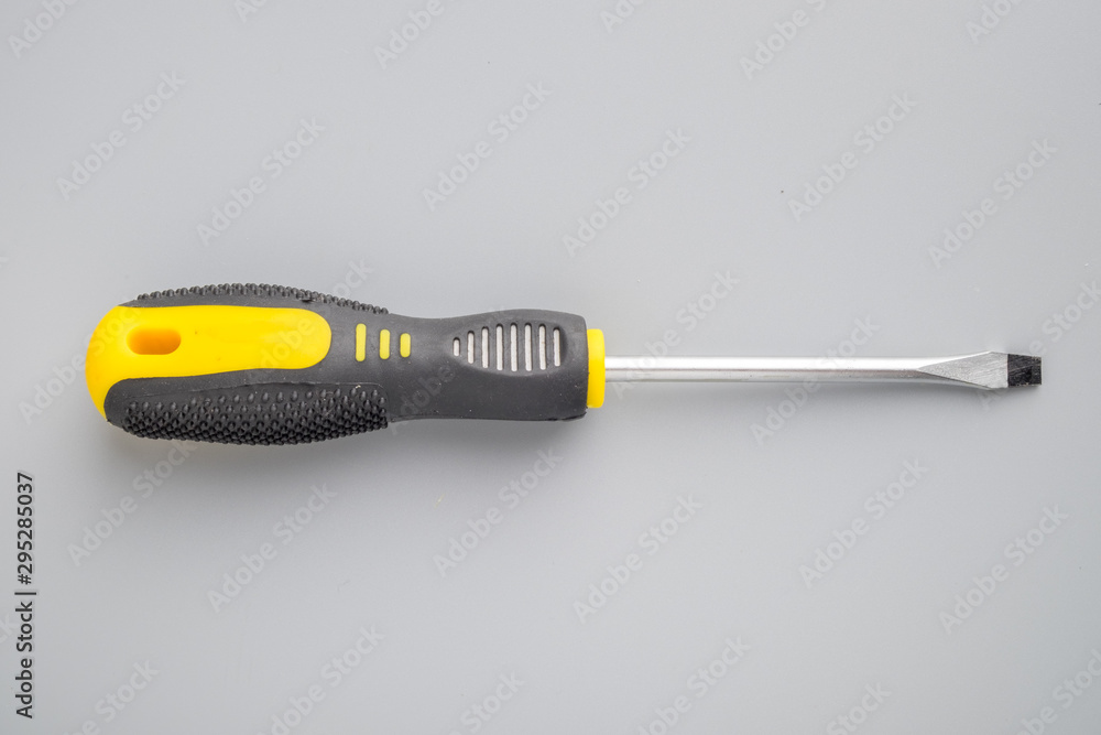 Screwdriver on grey background Screwdriver on grey background