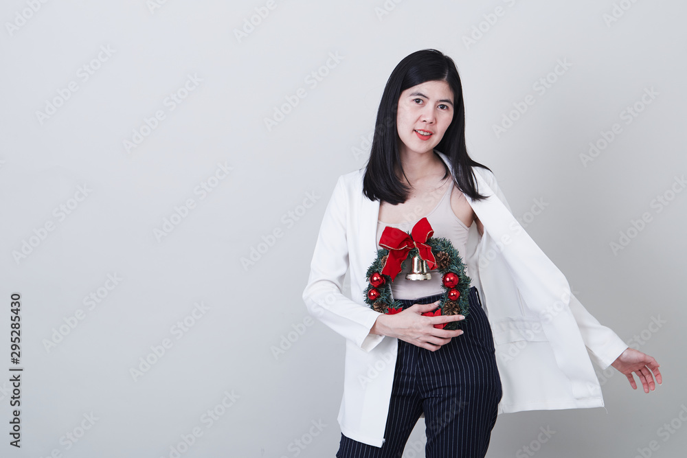 Cheerful christmas young asian woman gesturing Cheerful christmas young asian woman gesturing