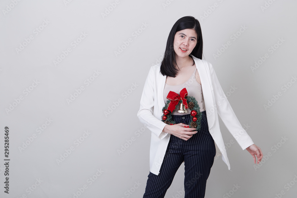 Cheerful christmas young asian woman gesturing Cheerful christmas young asian woman gesturing