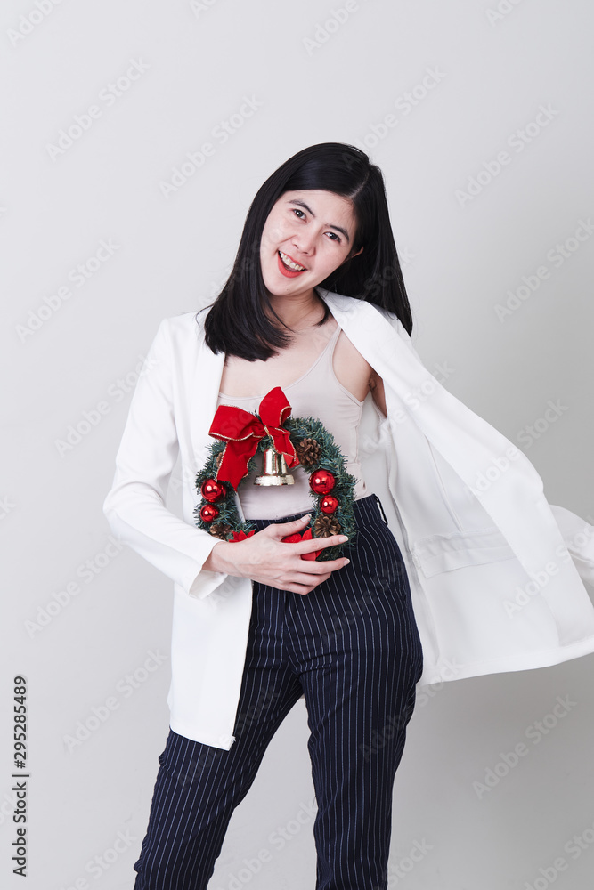 Cheerful christmas young asian woman gesturing Cheerful christmas young asian woman gesturing