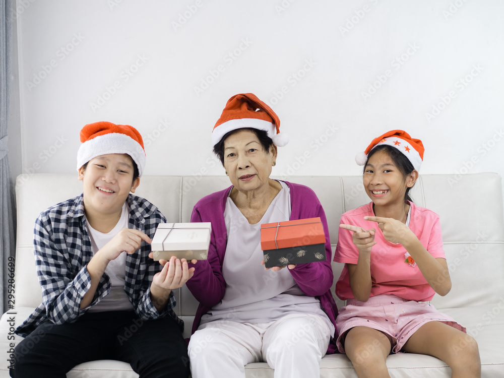 Fototapeta premium Asian children give present to their grandmother, lifestyle concept.