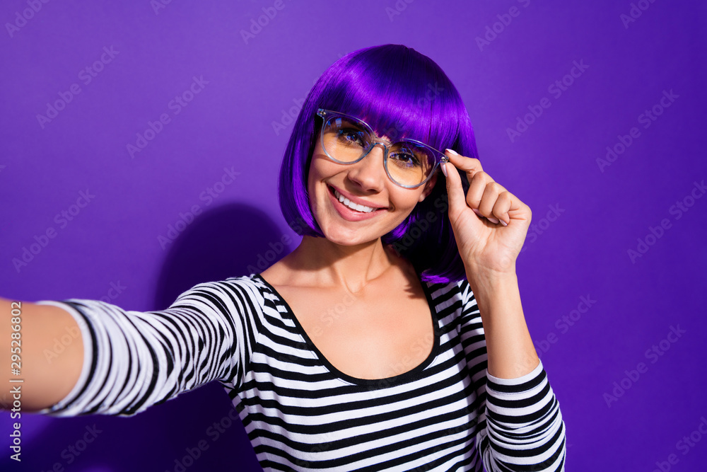 Close up photo of cheerful lady touch specks make photo smiling isolated over purple violet background Close up photo of cheerful lady touch specks make photo smiling isolated over purple violet background
