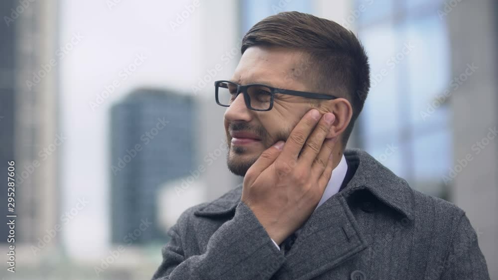 Talking phone man feeling unpleasant pain, inflammation of inner ear, eardrum Talking phone man feeling unpleasant pain, inflammation of inner ear, eardrum