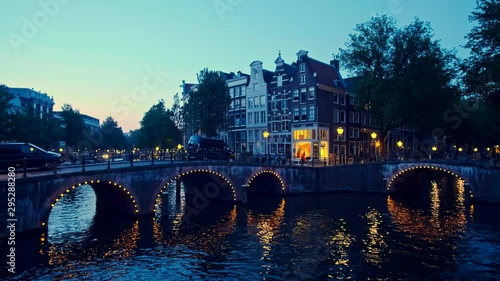 Amterdam canal, bridge and medieval houses in the evening photo