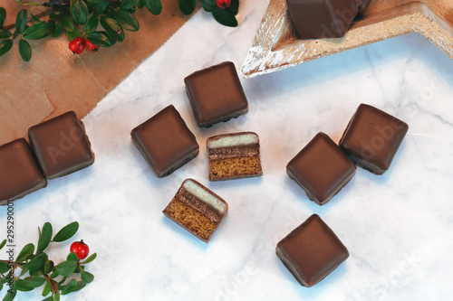 German traditional sweets called 'Dominosteine',  food sold around Christmas season consisting of gingerbread, jelly and marzipan layers and covered with chocolate icing  photo