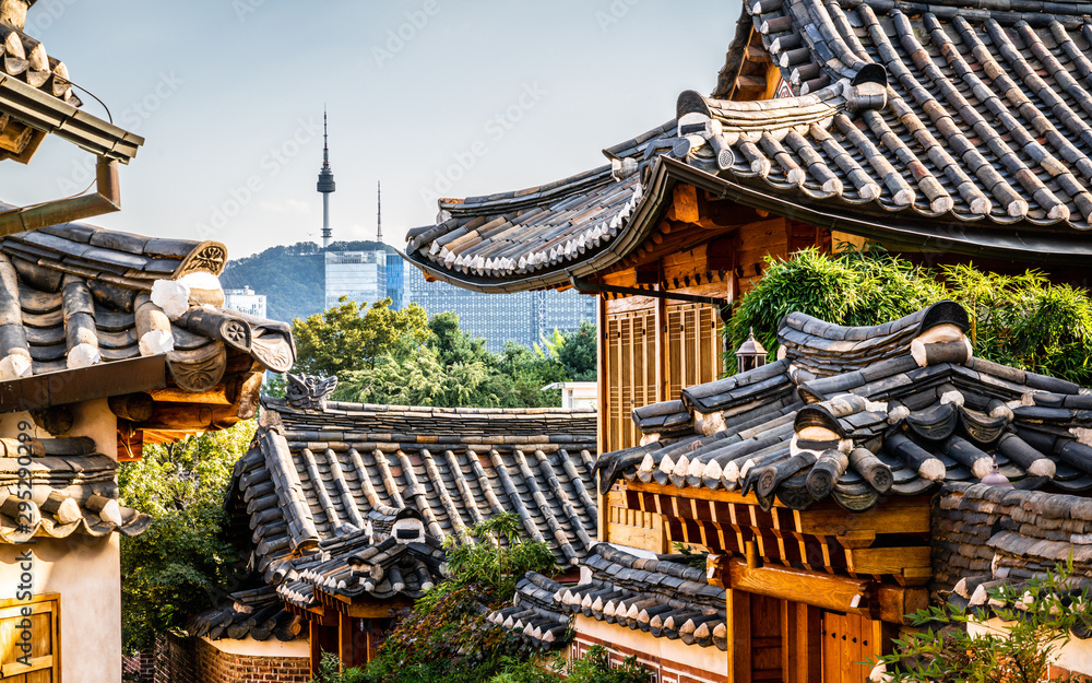 Bukchon Hanok village scenic view in Seoul with view on roofs and tower in the distance in Korea Bukchon Hanok village scenic view in Seoul with view on roofs and tower in the distance in Korea