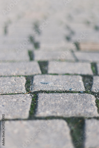 Abstract gray background of old street cobblestone street close up. Selective focus