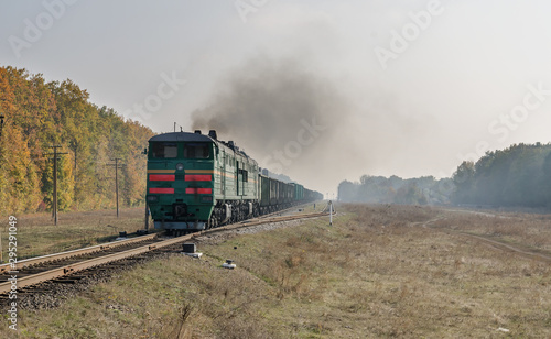old locomotive with smoke pollution on railway