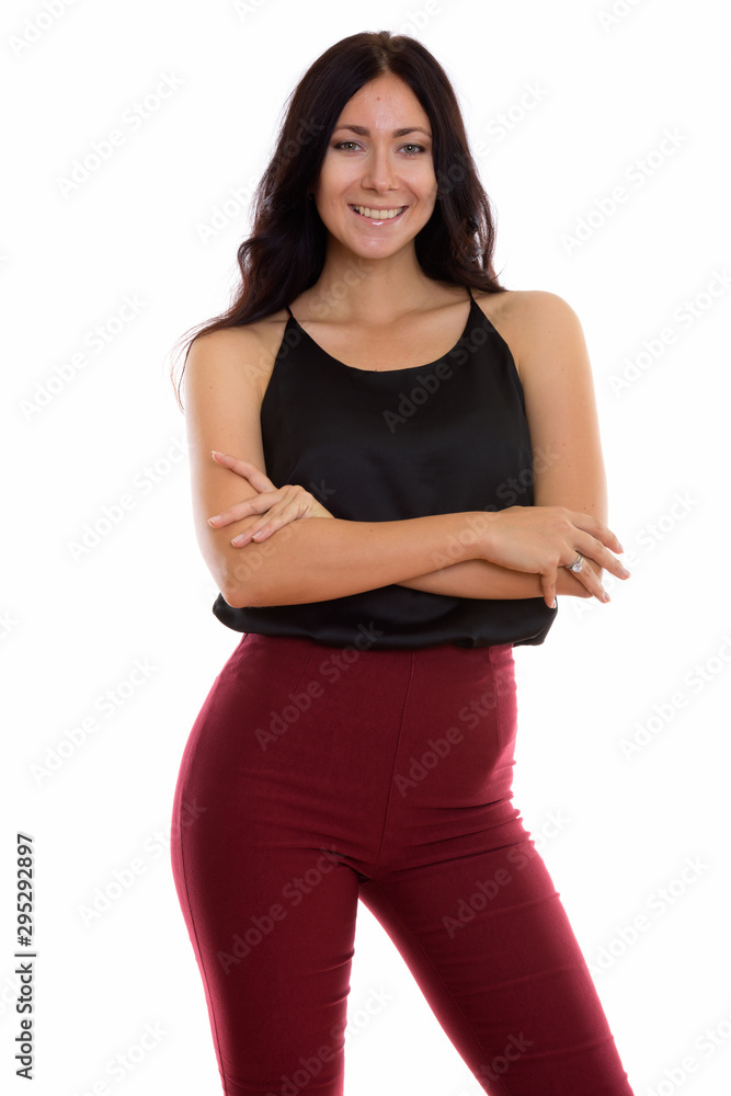Studio shot of young happy businesswoman smiling and standing wi Studio shot of young happy businesswoman smiling and standing wi