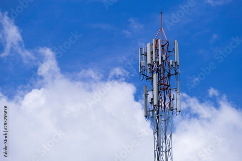 Telecommunication telephone signal transmission tower with beautiful blue sky and cloudy background