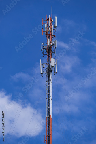 Telecommunication telephone signal transmission tower with beautiful blue sky and cloudy background