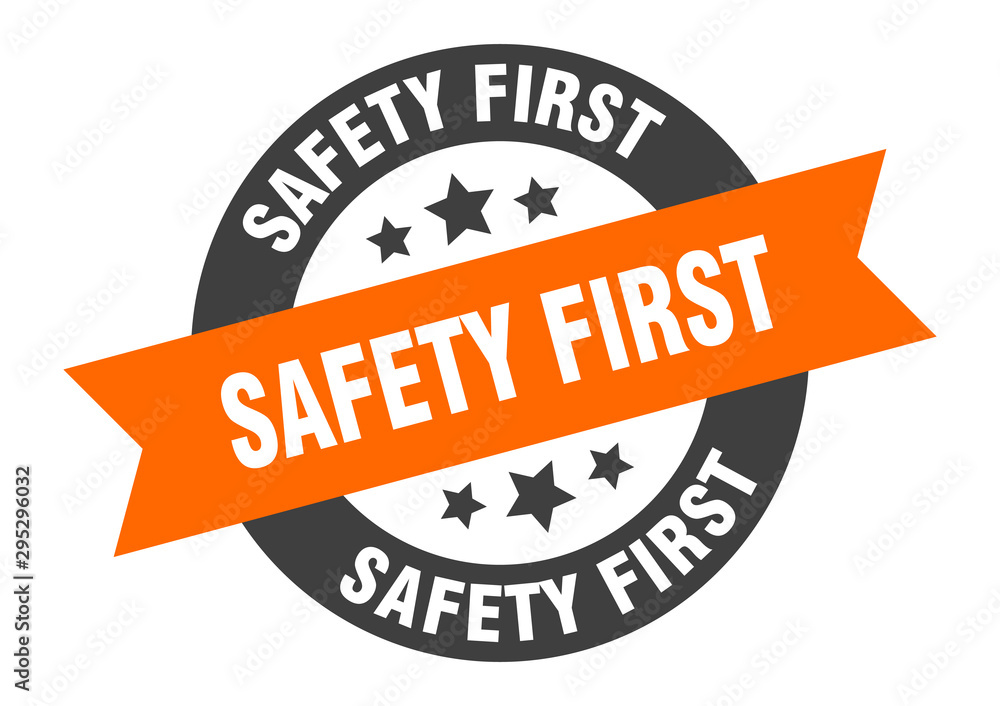 Obraz premium safety first sign. safety first orange-black round ribbon sticker
