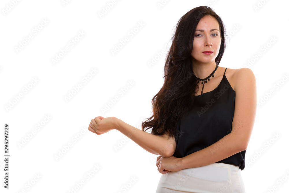 Studio shot of young beautiful businesswoman with arm resting on