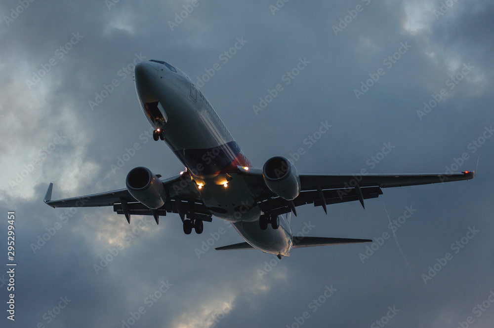 Silhouette of a passenger airliner in the sky during sunset. Airplane in the sky. Silhouette of a passenger airliner in the sky during sunset. Airplane in the sky.