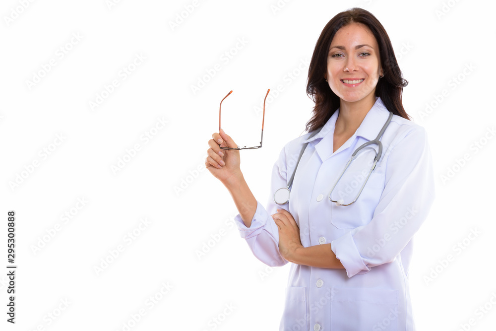 Studio shot of young happy woman doctor smiling while holding ey Studio shot of young happy woman doctor smiling while holding ey