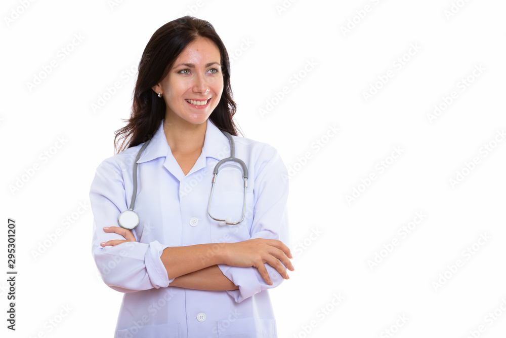 Studio shot of young happy woman doctor smiling and thinking wit Studio shot of young happy woman doctor smiling and thinking wit