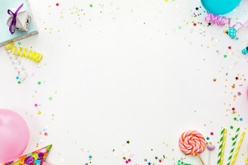 Birthday party background. party hats, balloons, streamers and confetti with copy space