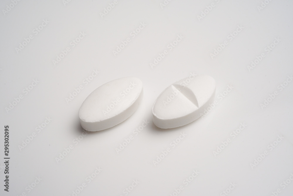 White pills on white background White pills on white background