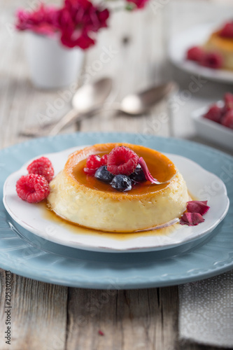 Caramel custard pudding with mint and caramel syrup on grey  background. Flan dessert made of eggs