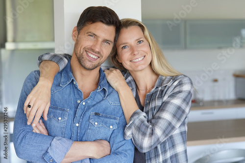 Portrait of cheerful middle-aged couple at home photo