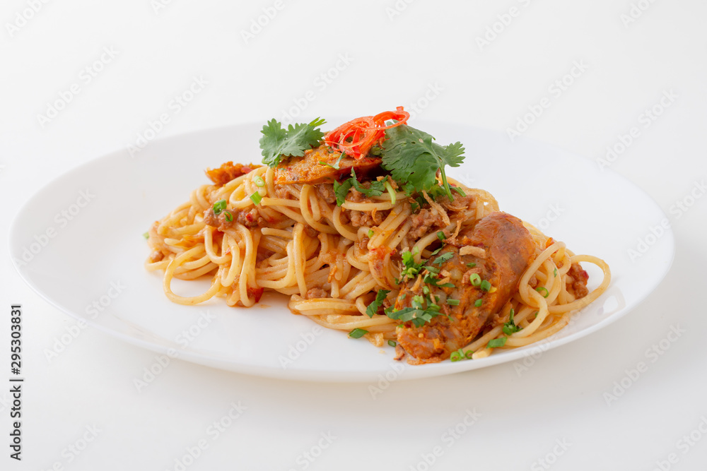 Spicy Spaghetti with Thai sausage on wood table. Spicy Spaghetti with Thai sausage on wood table.