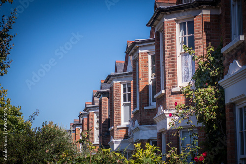 Row of typical British red brick terraced houses