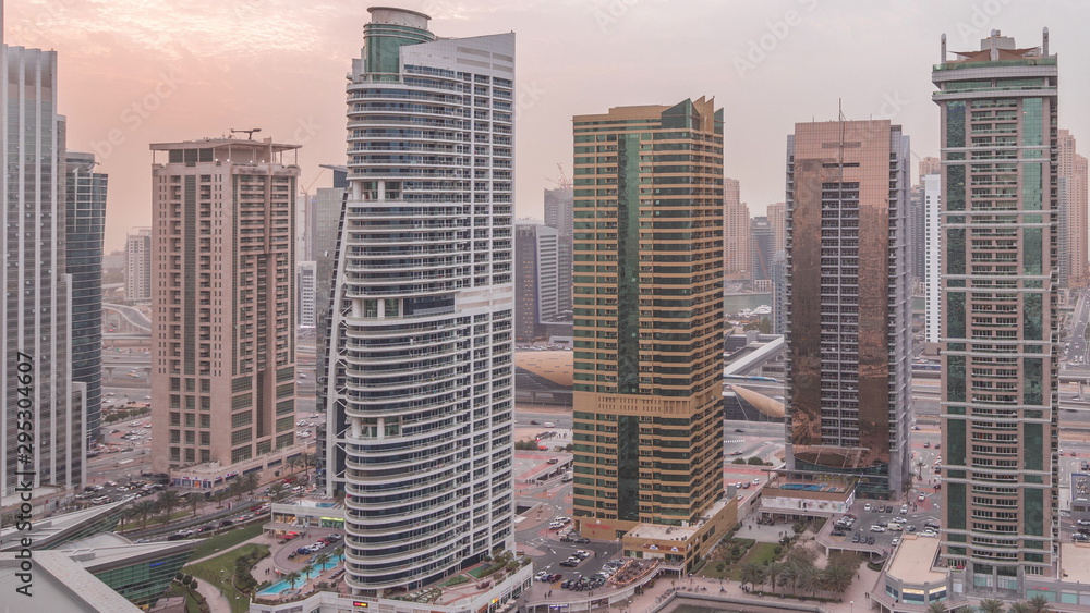 Residential and office buildings in Jumeirah lake towers district day to night timelapse in Dubai