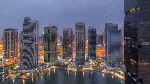 Residential and office buildings in Jumeirah lake towers district night to day timelapse in Dubai © neiezhmakov