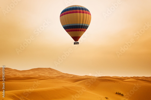 Desert and hot air balloon Landscape at Sunrise. Travel, inspiration, success, dream, flight concept © Kotangens