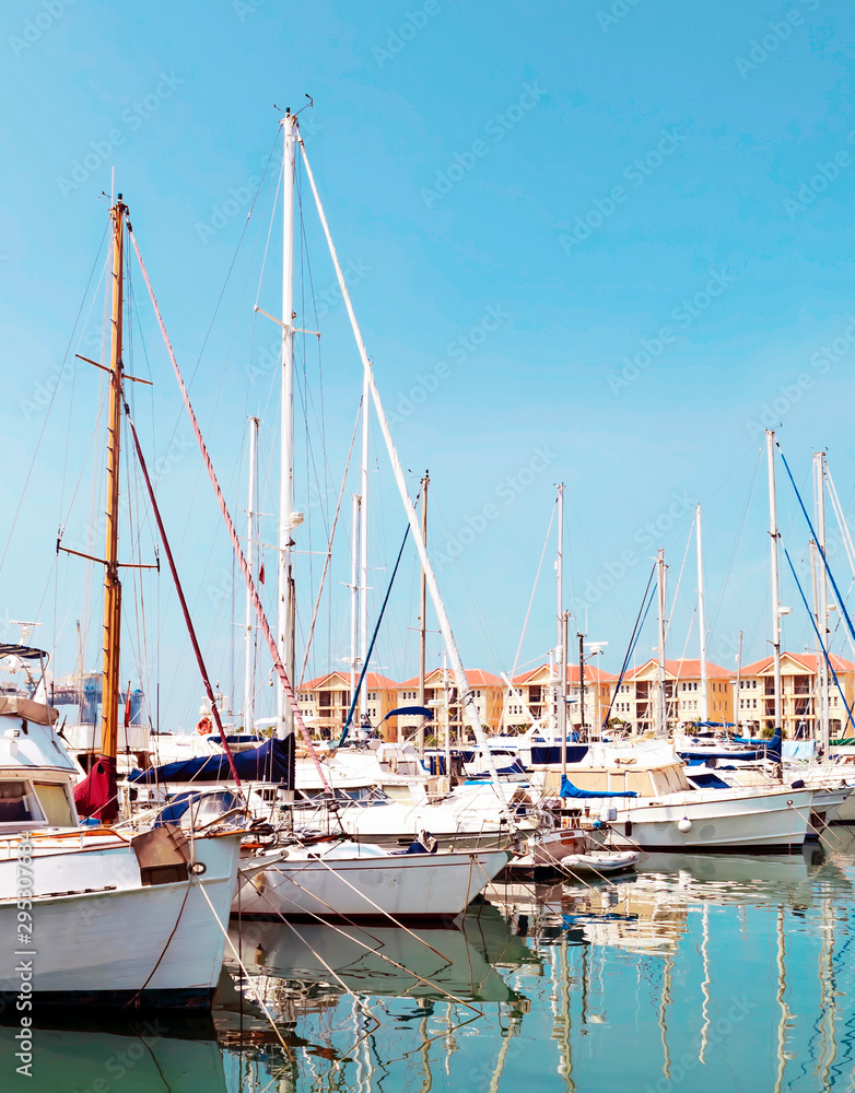 Boats in the port of Gibraltar, with the modern buildings in the background in a sunny day