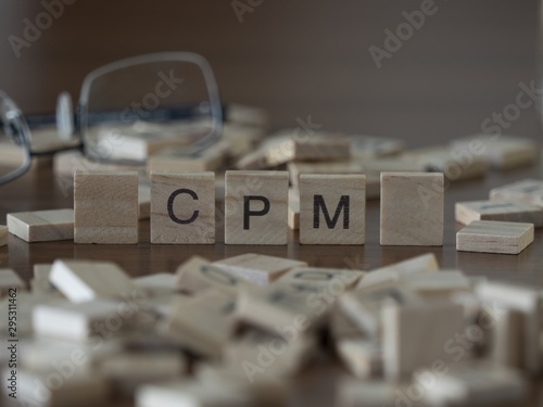 The concept of Cpm represented by wooden letter tiles photo