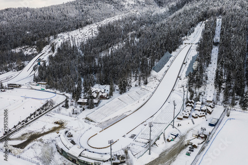 Large ski jump in Zakopane called Huge Krokiew names Stanislawa Marusarza, winter aerial view.