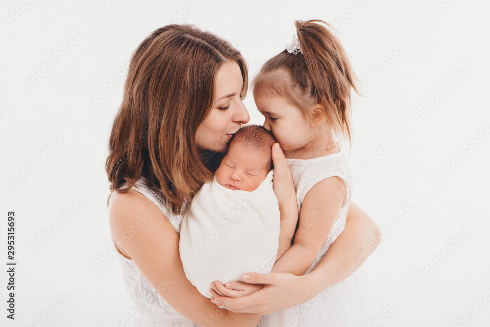 family photo on a white background: woman and boy spend time with children. hug the baby. the concept of childhood, fatherhood, motherhood, IVF family photo on a white background: woman and boy spend time with children. hug the baby. the concept of childhood, fatherhood, motherhood, IVF