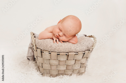 newborn baby wrapped in a blanket sleeping in a basket. concept of childhood, healthcare, IVF. Black and white photo
