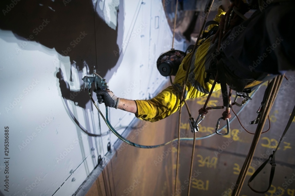 Close up picture of rope access painter working at height abseiling upside  down wearing safety chemical protective mask commencing spray painting in  confined space construction site Perth, Australia Stock-Foto | Adobe Stock