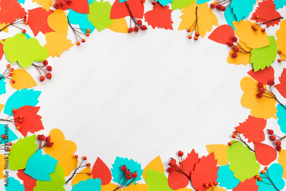 Fototapeta Autumn composition frame Paper colored leaves branches berries on white background The concept of autumn Flat lay top view