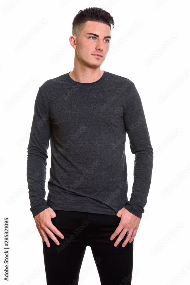 Studio shot of young handsome man standing and thinking Studio shot of young handsome man standing and thinking
