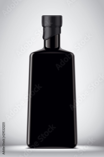 Glass black bottle on gray background