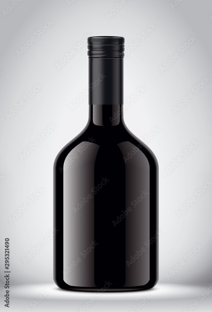 Glass black bottle on gray background Glass black bottle on gray background