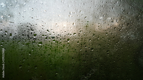 Rain drops on a window with abstract lights with selective focus area. abstract backgrounds .