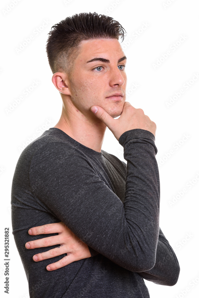 Studio shot of young handsome man thinking Studio shot of young handsome man thinking