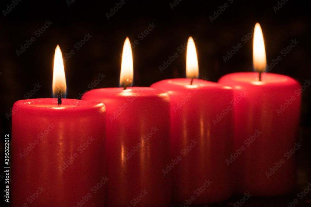 Burning candles on the fourth Sunday of Advent during Christmas season Burning candles on the fourth Sunday of Advent during Christmas season