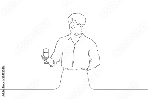 One continuous line drawing. A young attractive man holds a glass with a drink in his right hand, the left is laid behind. Waiter in a shirt and apron. It can be used for animation. Vector