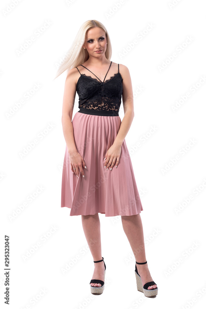 Uncertain displeased young blonde classy elegant woman looking away. Full body isolated on white background. 