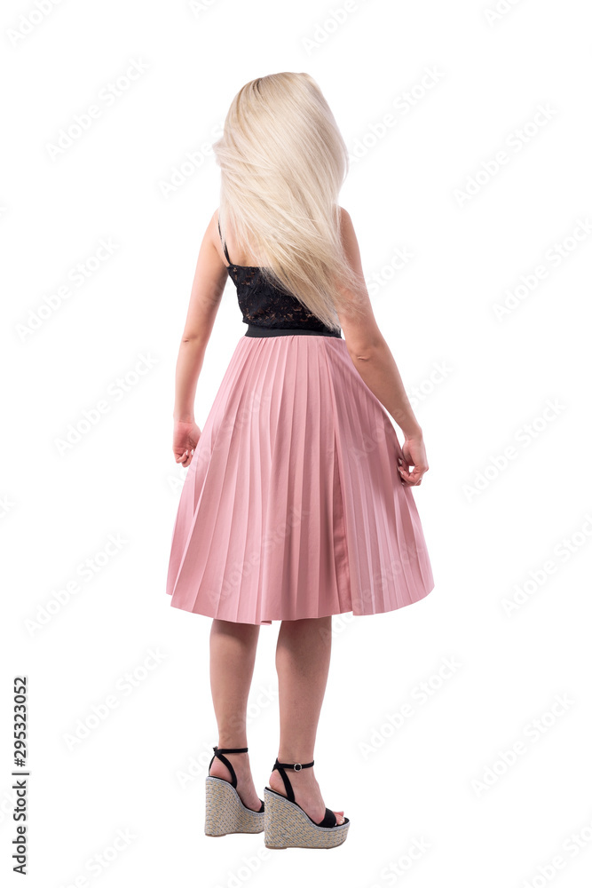 Naklejka premium Back view of spinning blonde long healthy smooth hair woman in motion. Full body isolated on white background. 