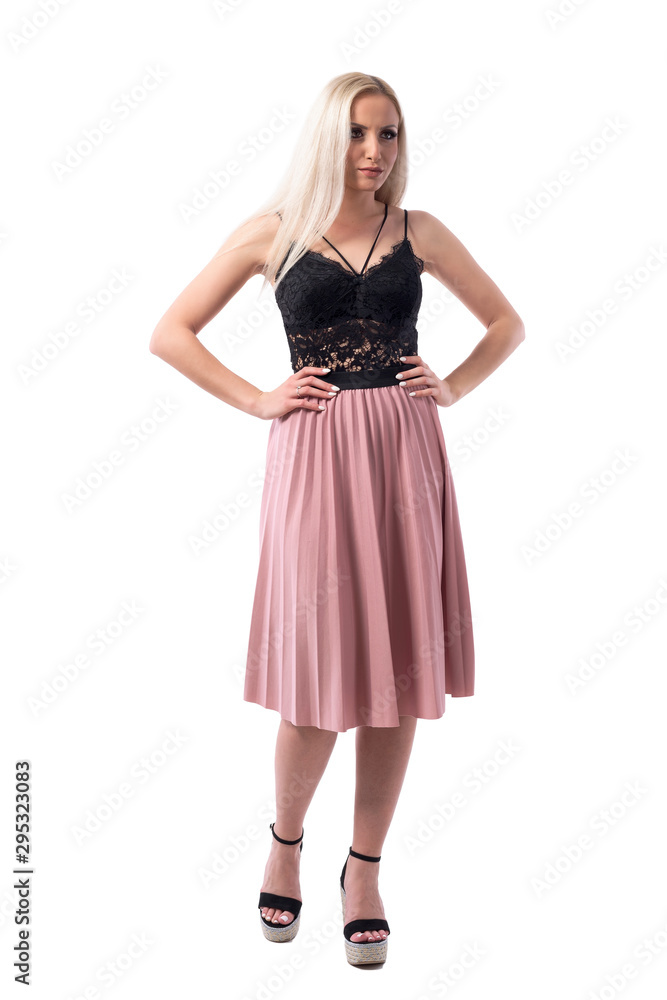 Angry displeased blonde woman in classy style with hands on hips looking away. Full body isolated on white background. 
