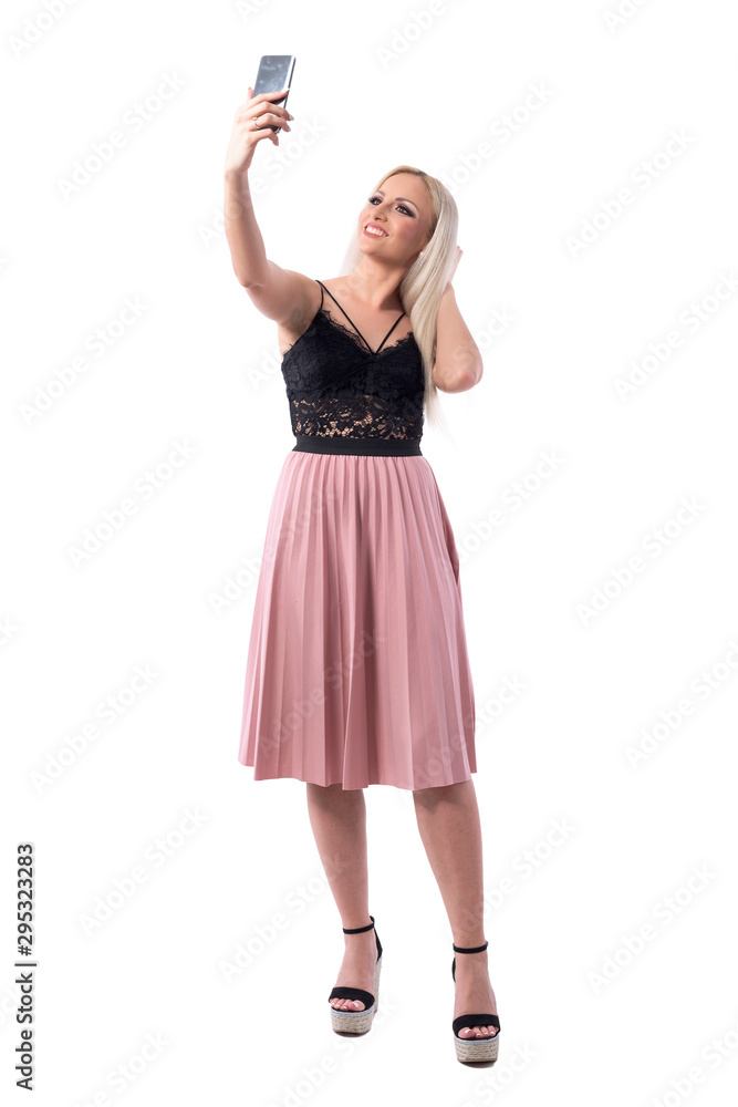 Stunning beauty classy woman posing for selfie showing healthy blonde hair. Full body isolated on white background. Stunning beauty classy woman posing for selfie showing healthy blonde hair. Full body isolated on white background.