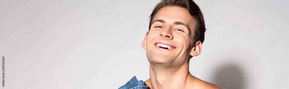 panoramic shot of happy man smiling on white panoramic shot of happy man smiling on white